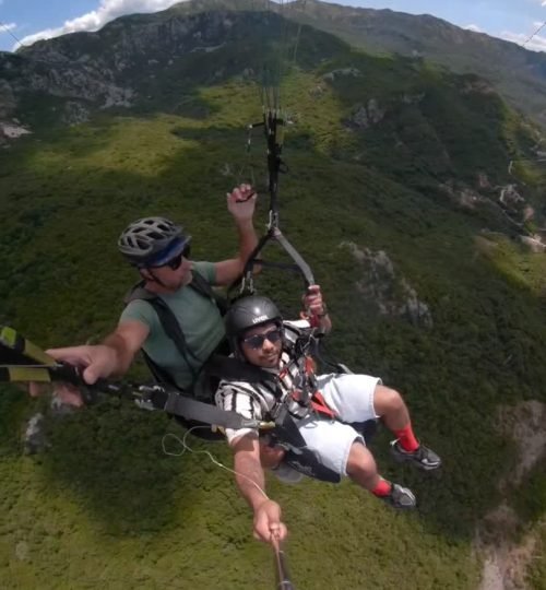 Paragliding flight high above Sveti Stefan and Kamenovo